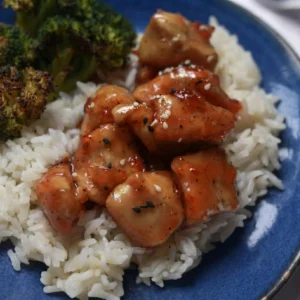 Orange Marmalade Chicken served over steamed white rice with sesame seeds and roasted broccoli.